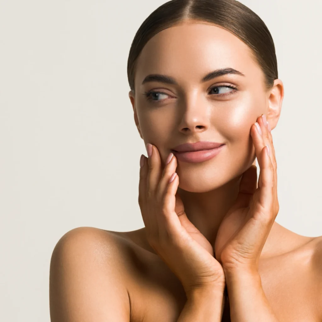 Model touching face with radiant, healthy complexion.